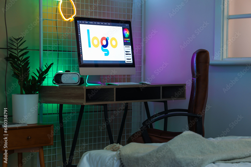 Table with modern computer and VR glasses in childrens bedroom