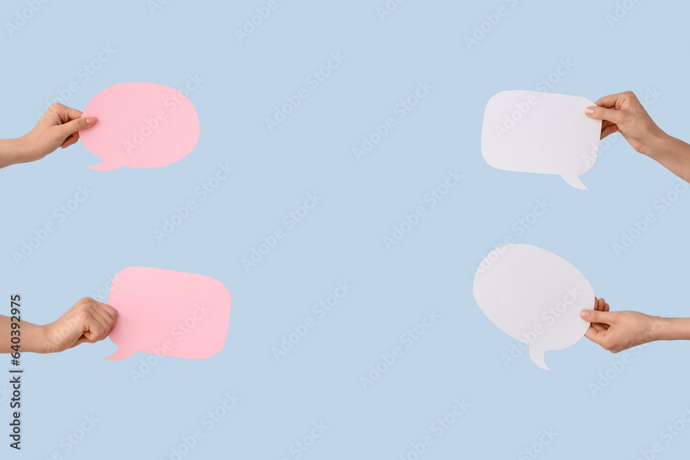 Female hands with speech bubbles on blue background