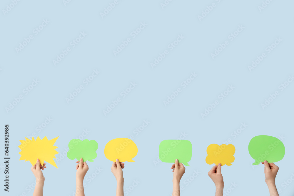 Female hands with speech bubbles on blue background