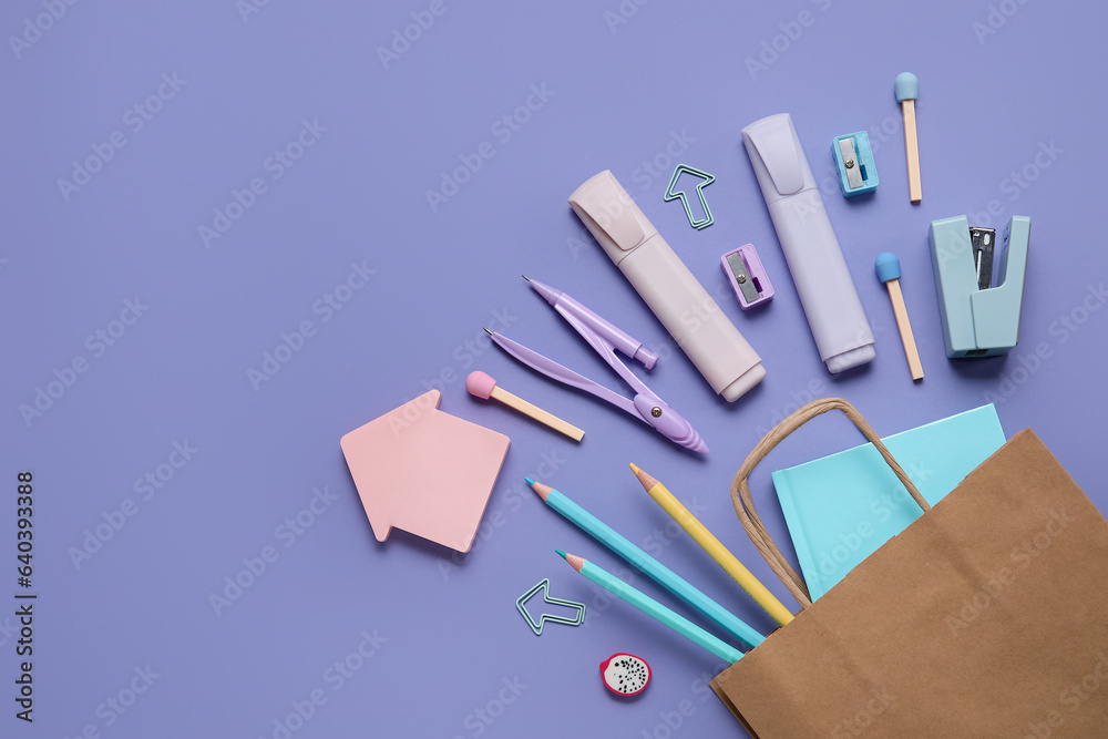 Shopping bag with different school stationery on purple background