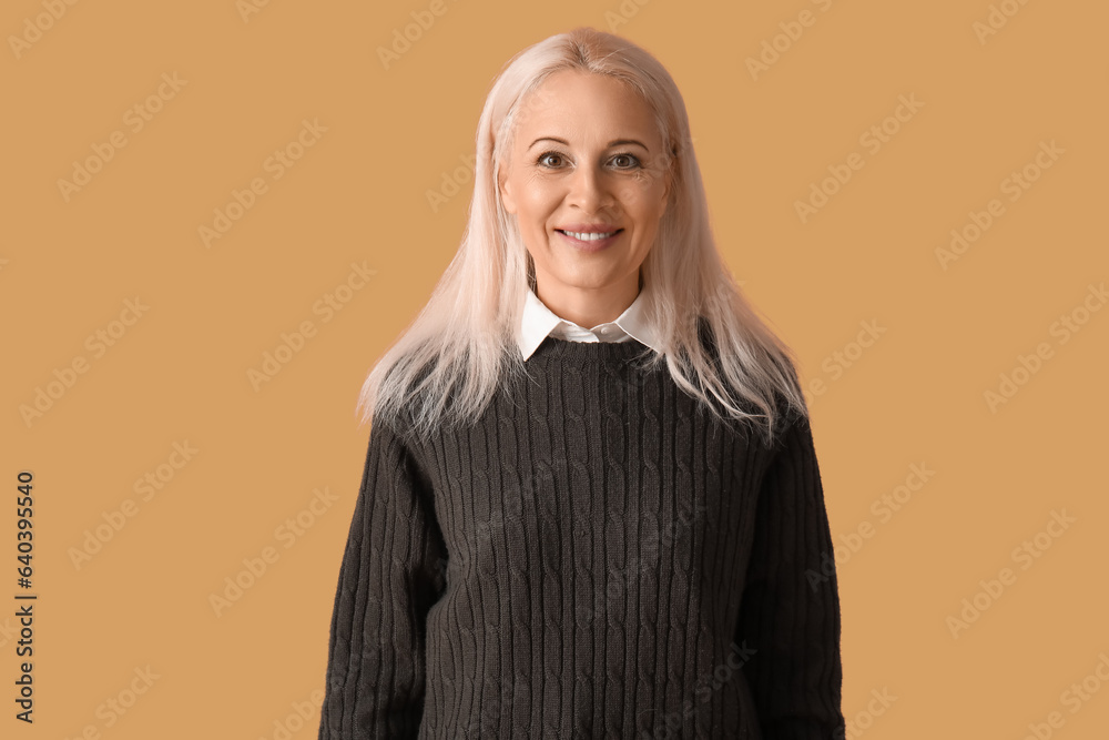 Mature woman on beige background