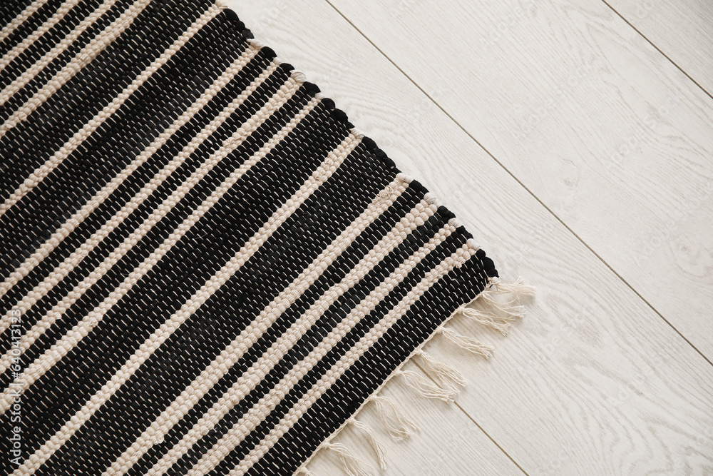 Stylish striped rug in living room, closeup