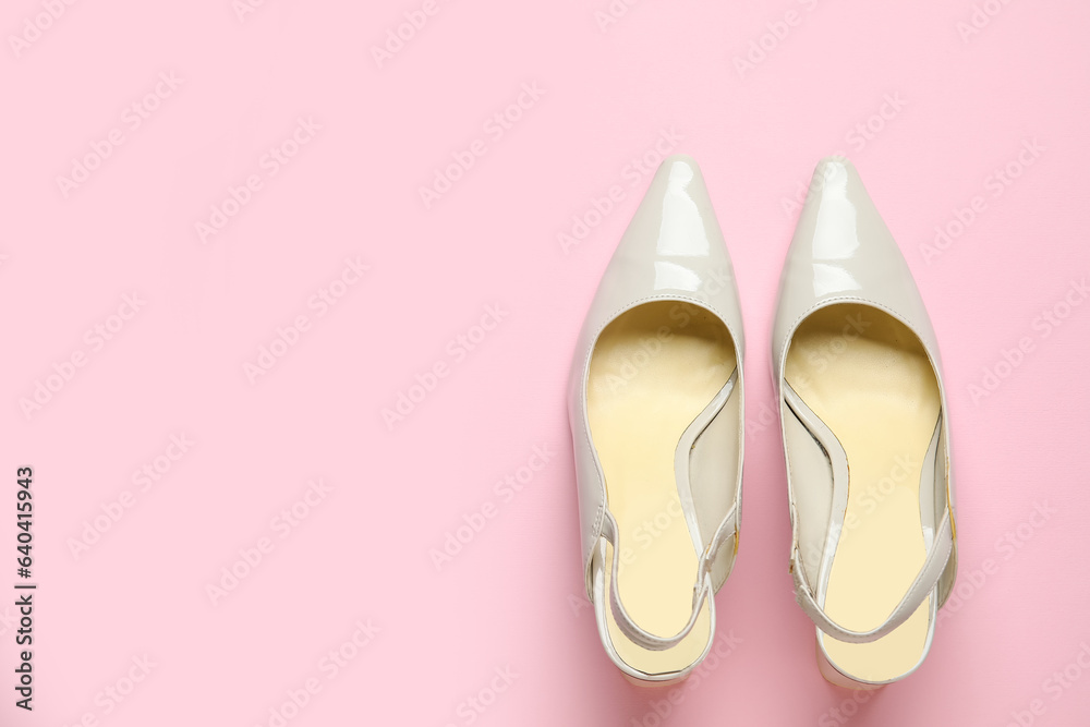 Stylish grey high heels on pink background