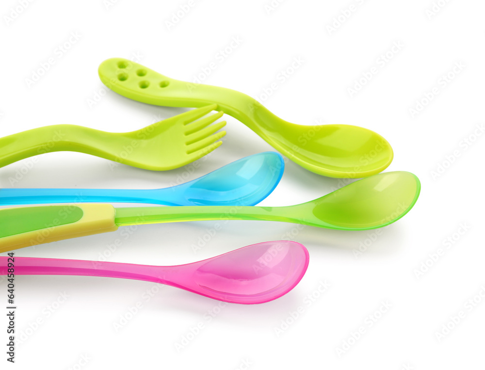 Colorful plastic cutlery for baby isolated on white background, closeup