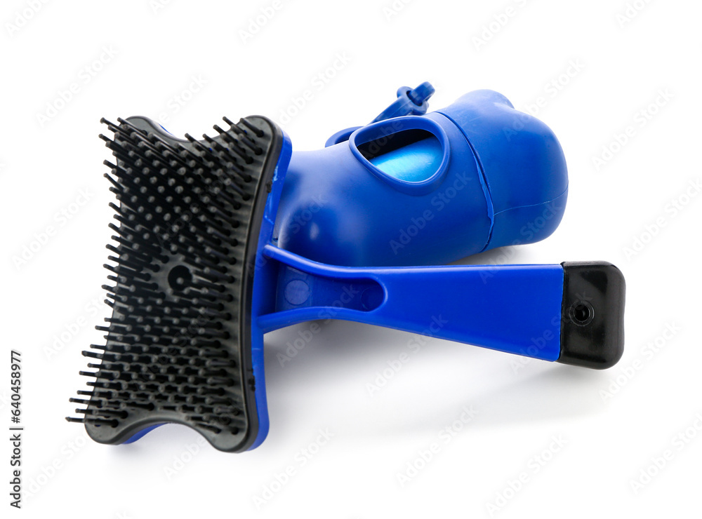 Grooming brush for pet and waste bags isolated on white background