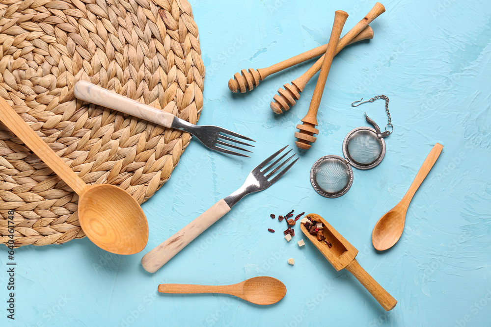 Different kitchen utensils on blue background