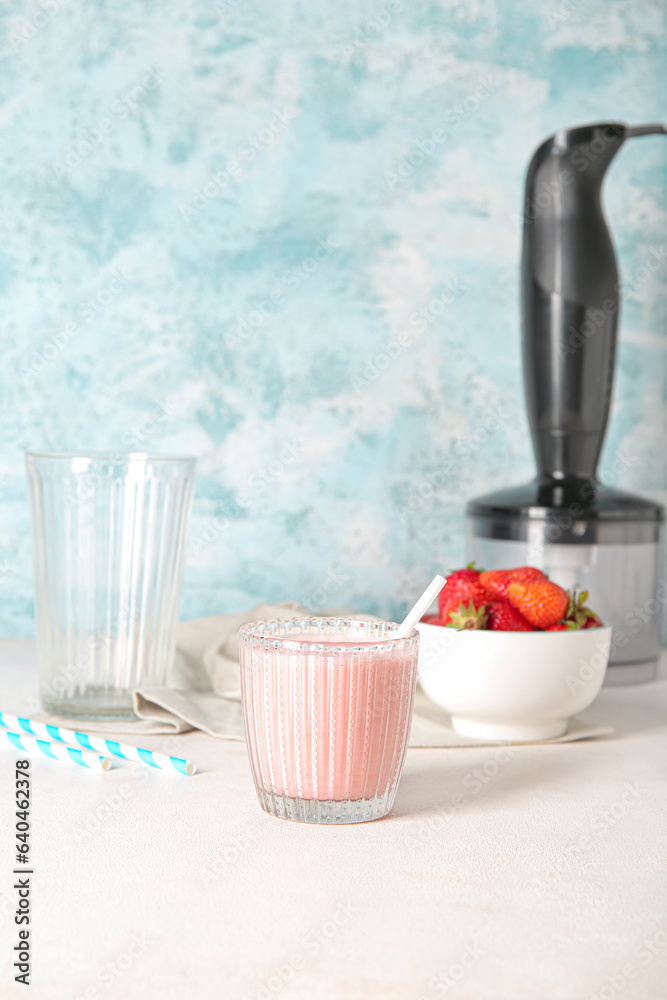 Glass of tasty strawberry smoothie on table