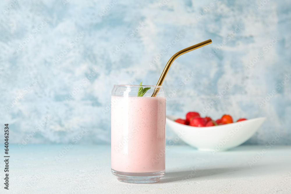 Glass of tasty strawberry smoothie on table