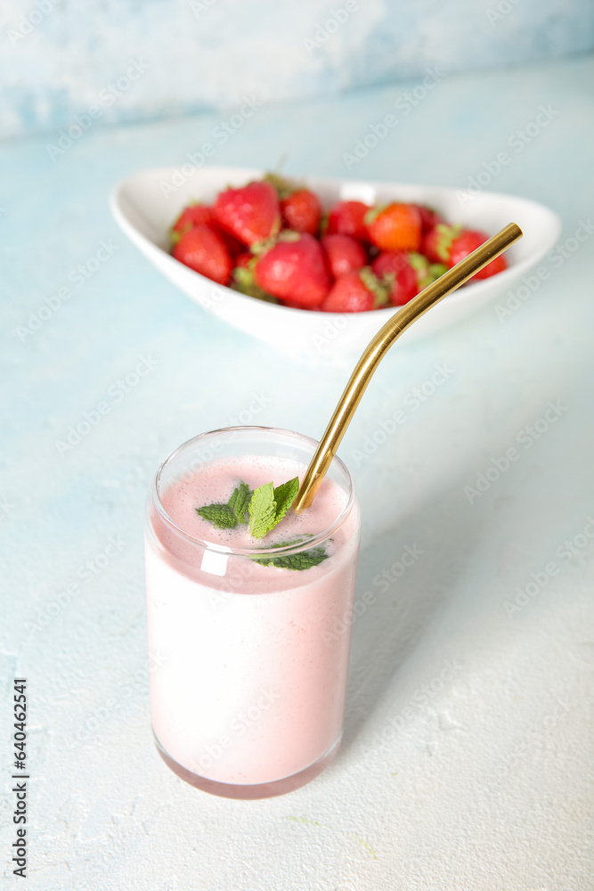 Glass of tasty strawberry smoothie on table