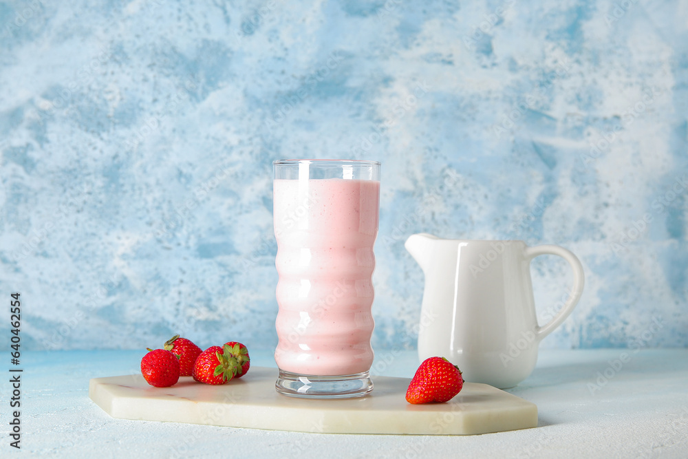 Glass of tasty strawberry smoothie on table