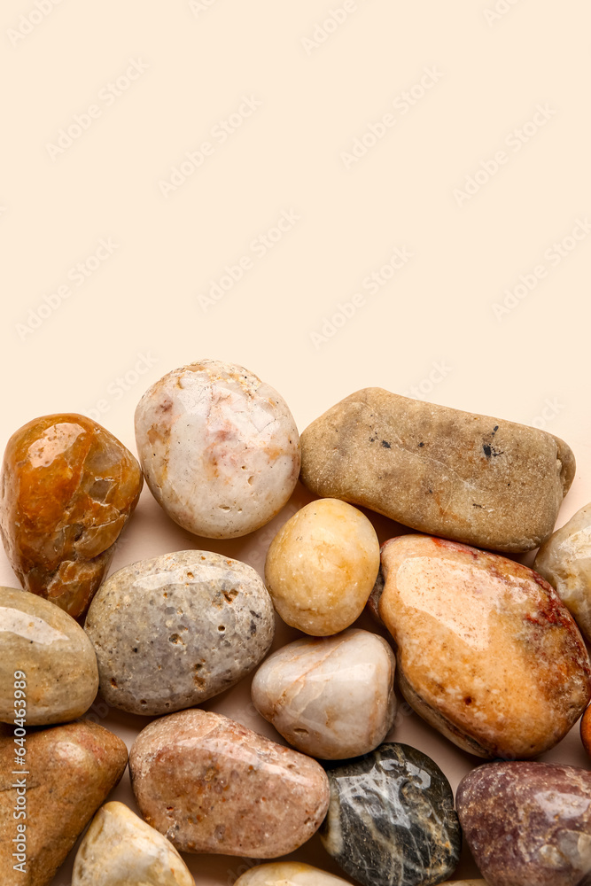 Many pebble stones on beige background