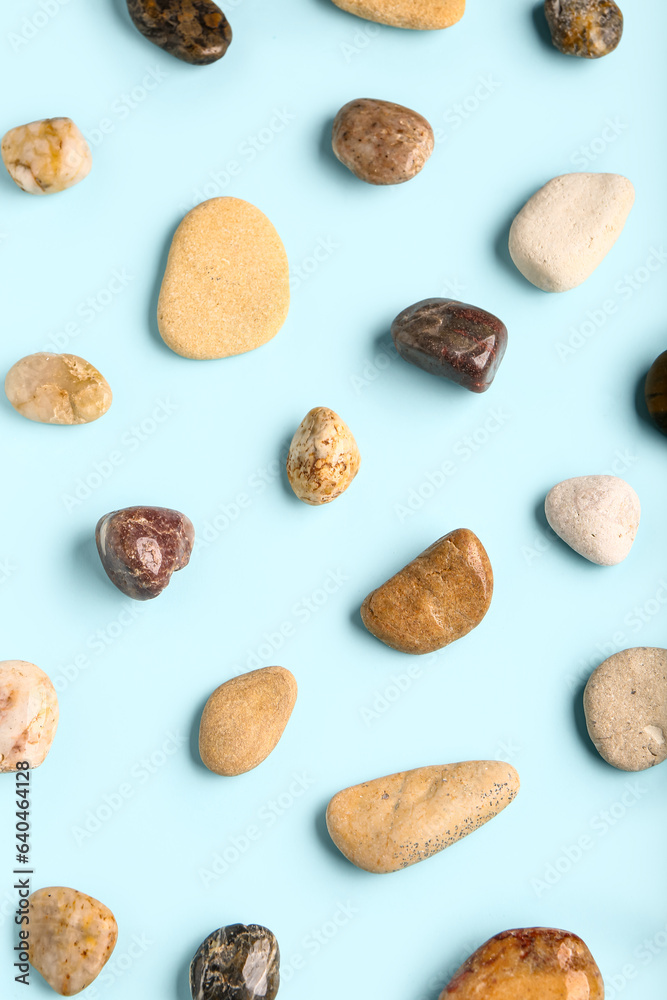 Many pebble stones on blue background