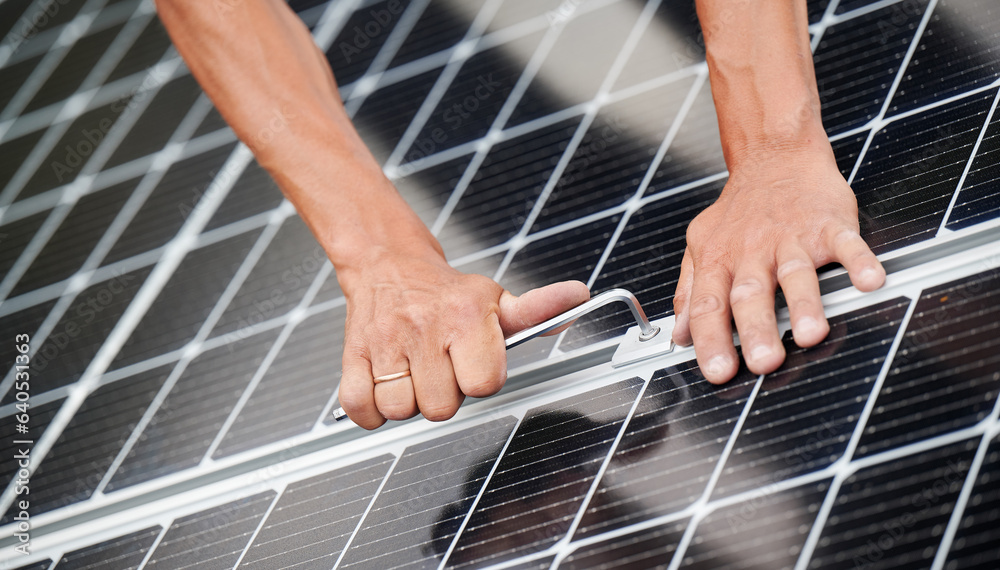 Man technician mounting photovoltaic solar moduls on roof of house. Close up of engineer installing 