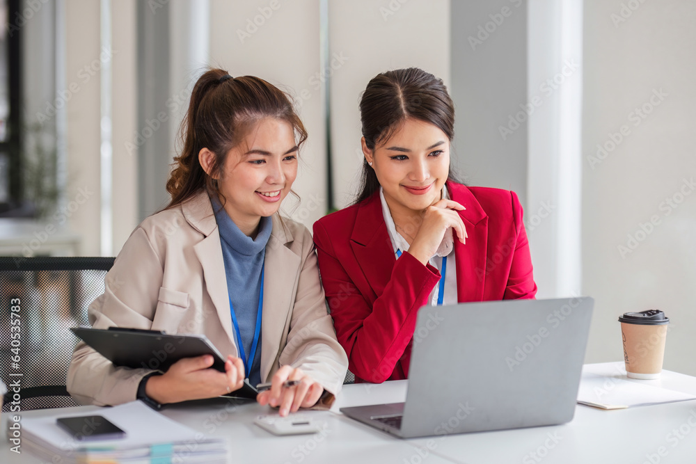 Two business women are discussing and exchanging knowledge on graphs and finance data.