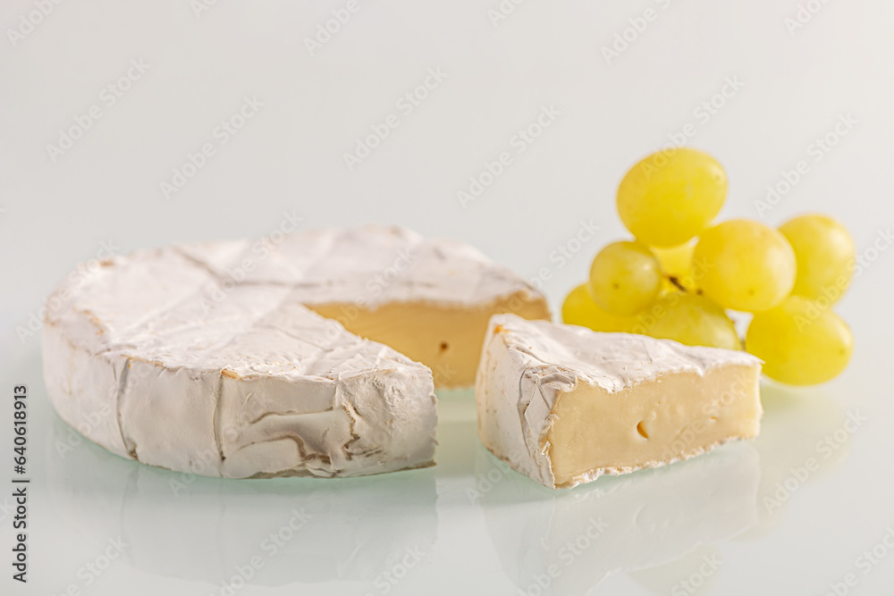 fresh delicious brie cheese and grapes close up shallow depth of field