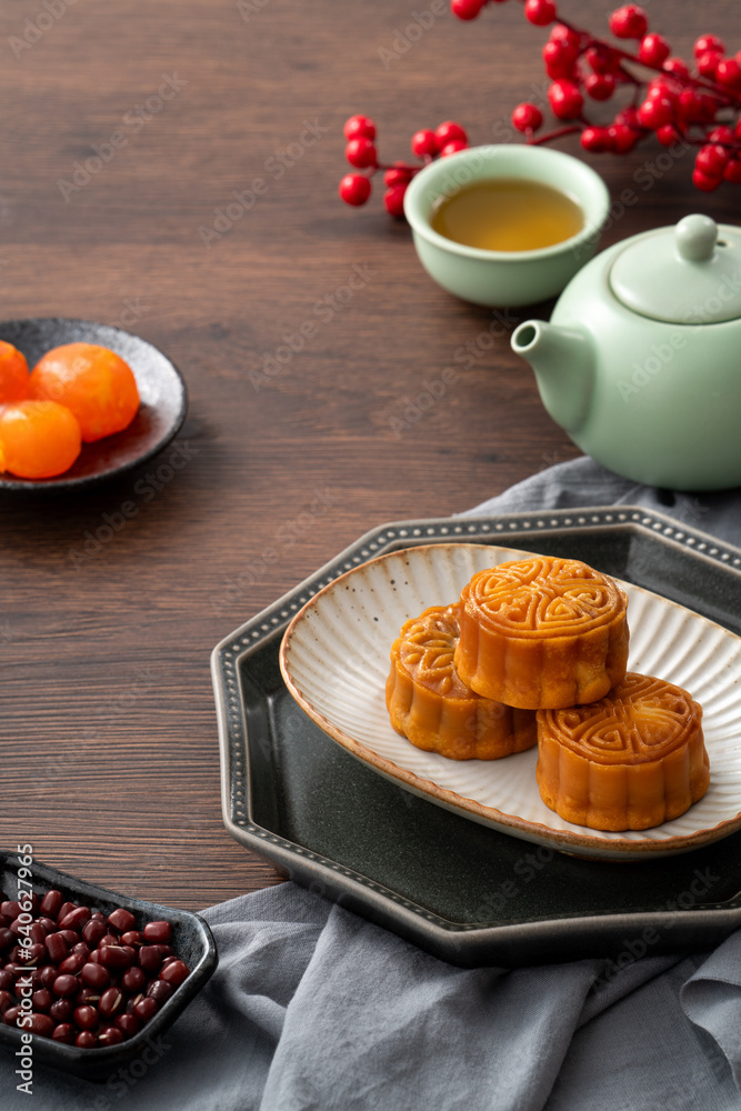 Delicious Cantonese moon cake for Mid-Autumn Festival food mooncake on wooden table background.