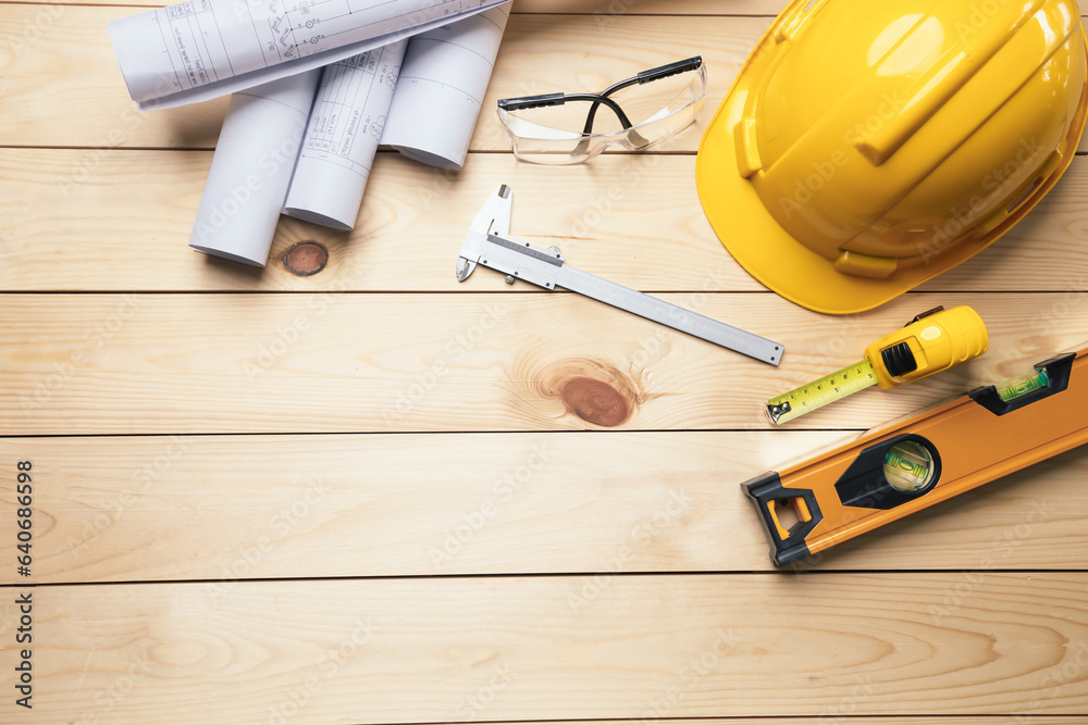 Work safety. Standard Construction site protective equipment on  top view wooden background, flat la