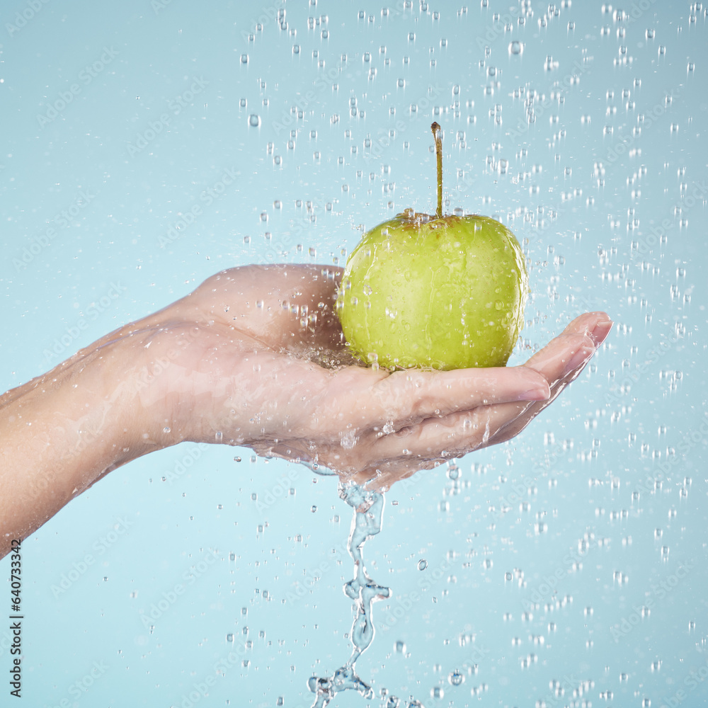 Person, hands and apple in water drops for diet, healthy wellness or eating plan against a blue stud