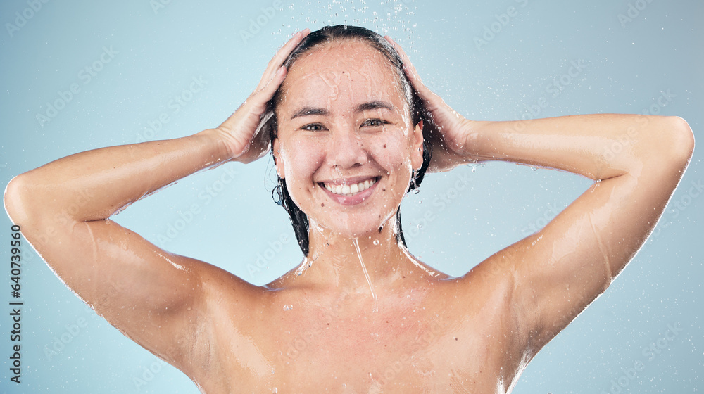 Face, shower and woman smile washing hair in studio isolated on blue background. Water splash, hygie