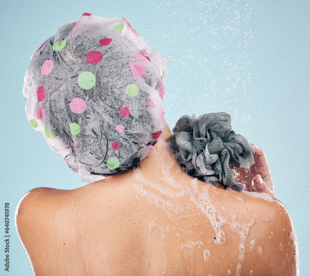 Person, shower and back in water drops for hygiene, grooming or washing against a blue studio backgr