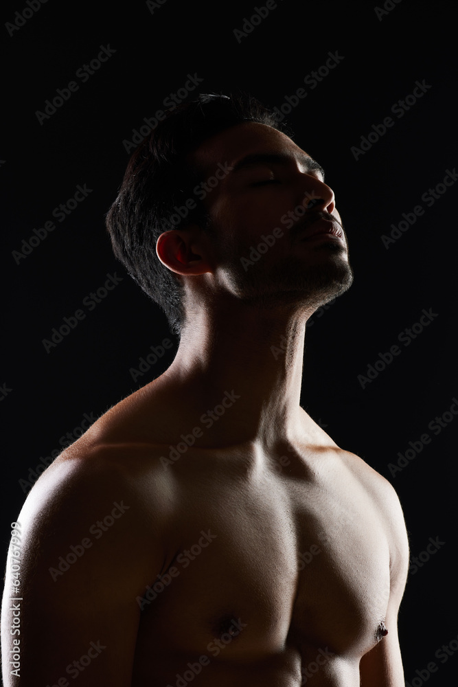 Bodybuilder man, muscle and shadow in studio with wellness, healthy body and black background. Young