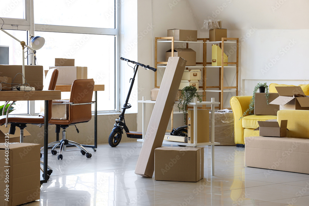 Interior of office with cardboard boxes on moving day