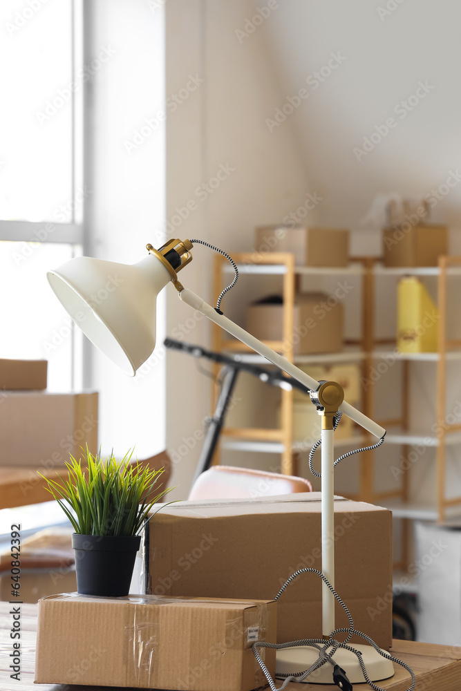 Interior of office with cardboard boxes on moving day