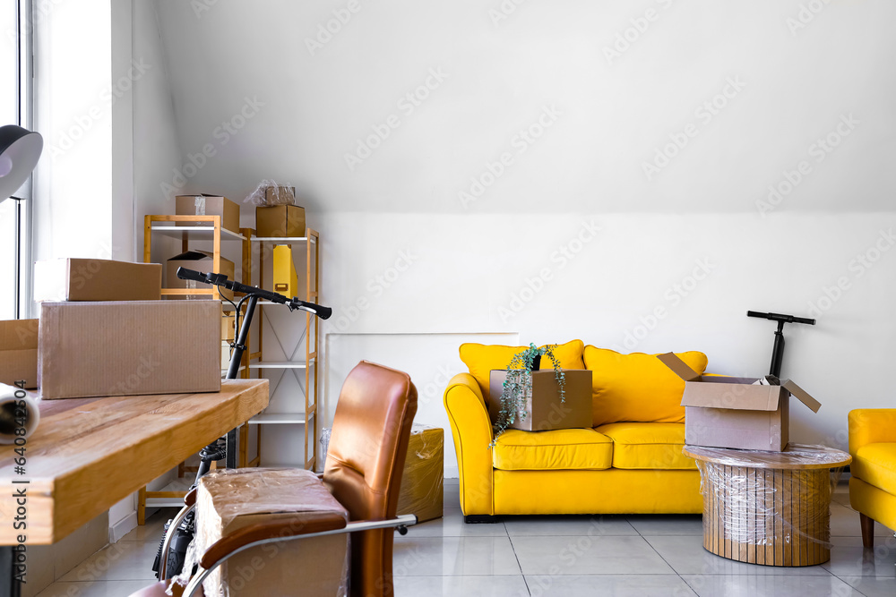 Interior of office with cardboard boxes on moving day