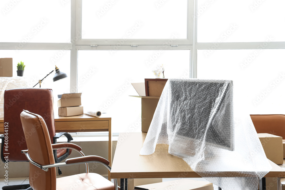 Desk with monitor wrapped in bubble film on moving day