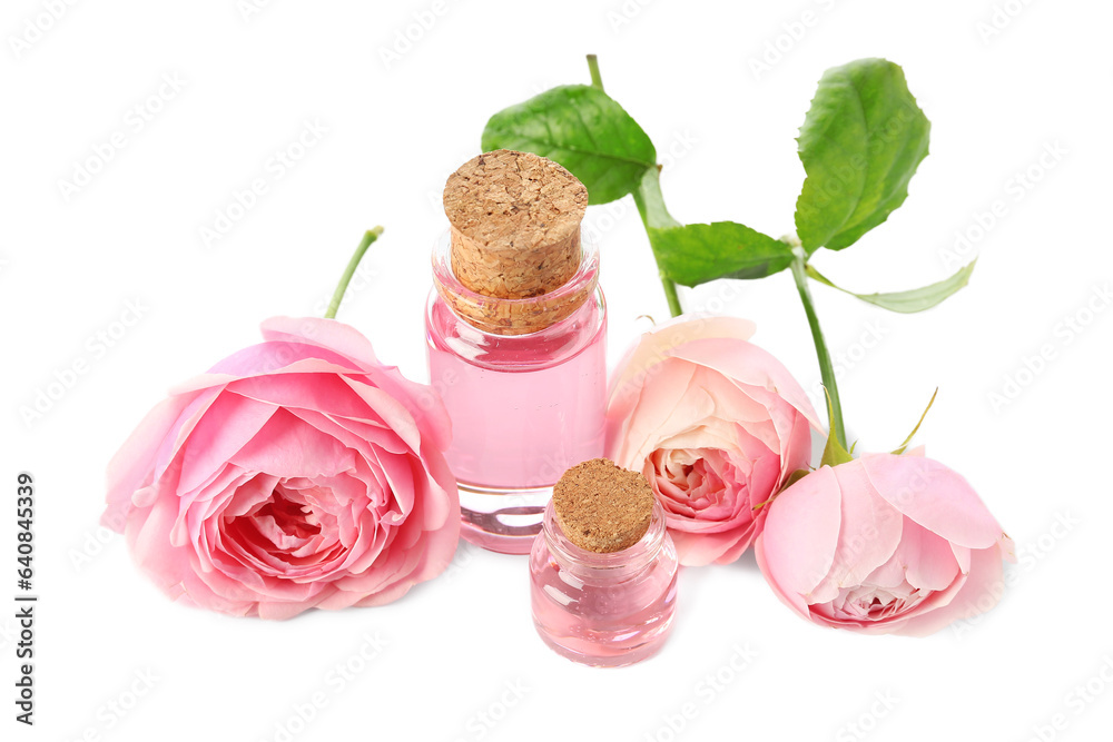 Bottles of cosmetic oil with rose extract and flowers on white background