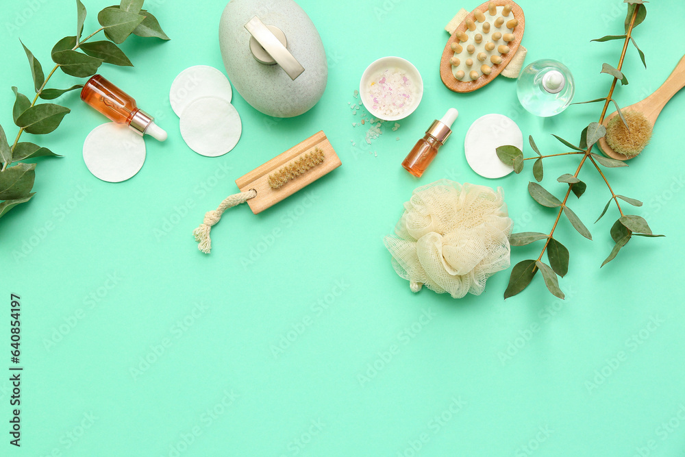 Composition with different bath supplies, cosmetic products and eucalyptus branches on color backgro