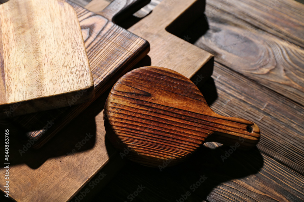 Different cutting boards on wooden background