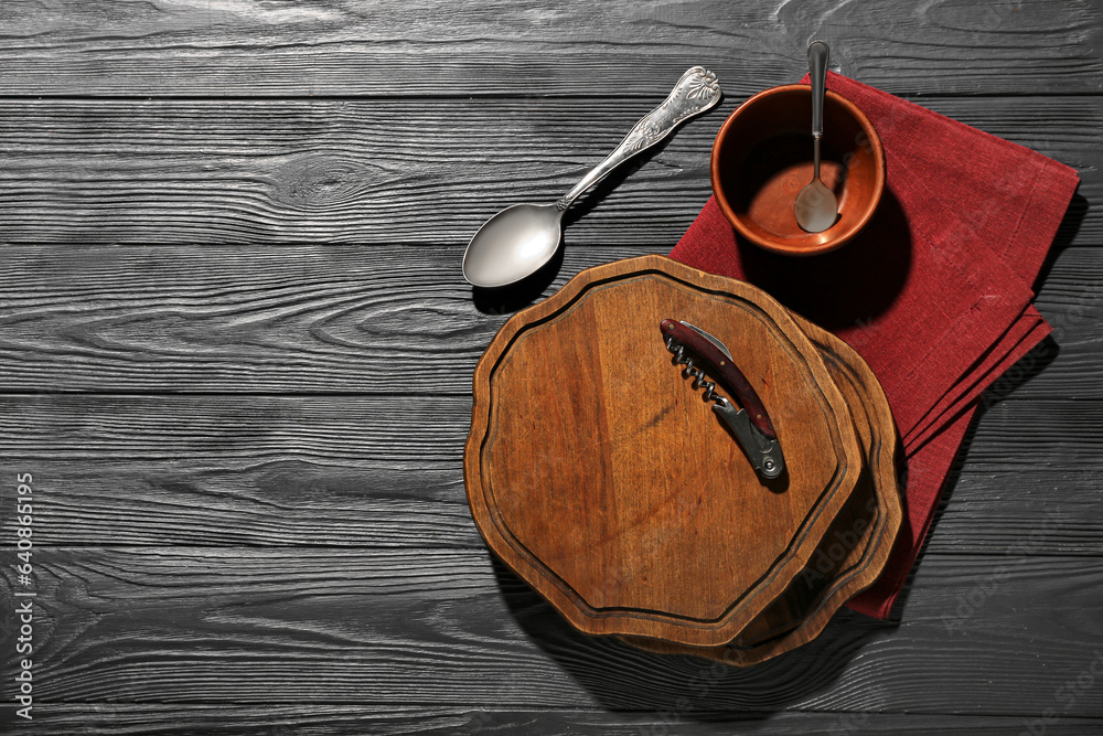 New cutting boards, bowl and spoons on grey wooden background