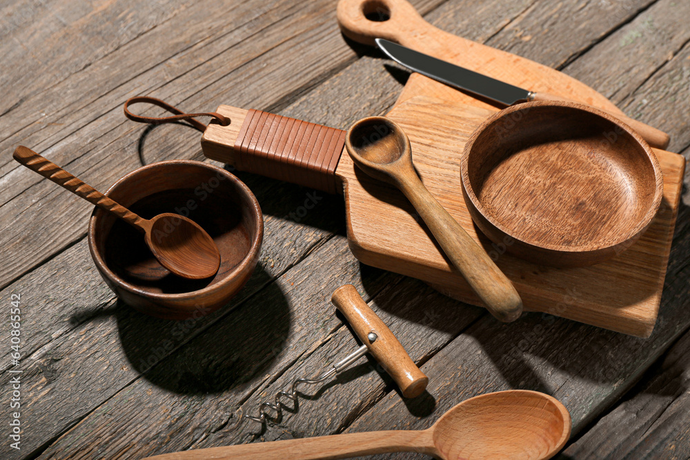 New cutting board, bowls and spoons on wooden background