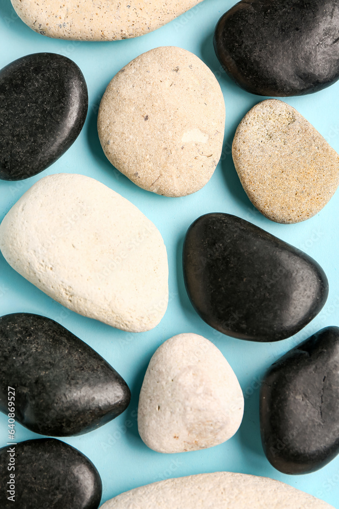 Many pebble stones on blue background