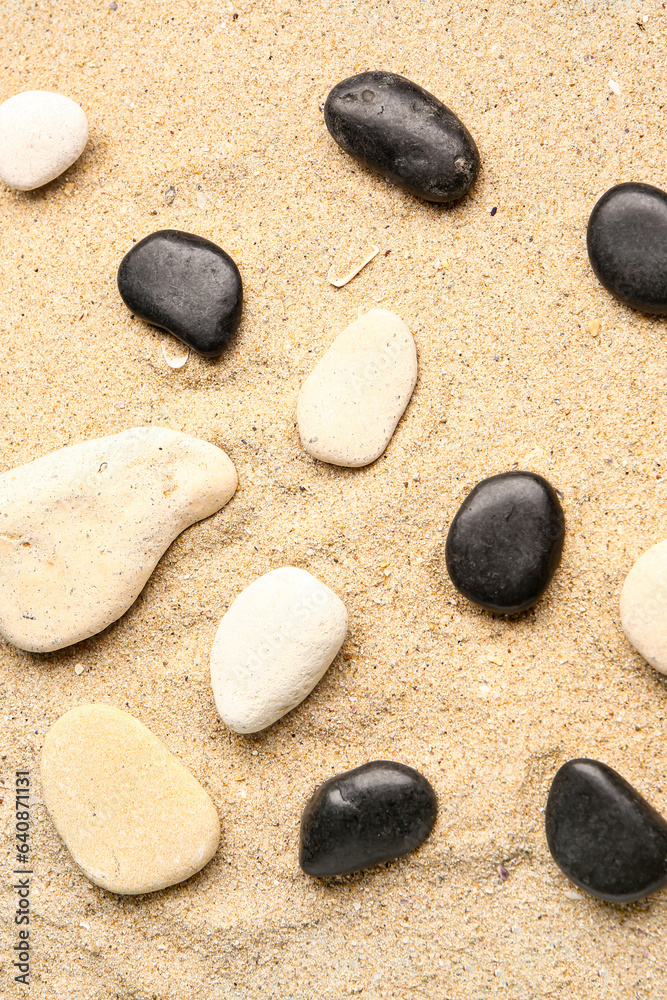 Many pebble stones on sand