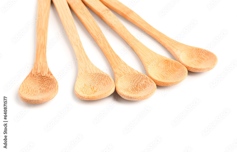 Empty wooden spoons isolated on white background, closeup