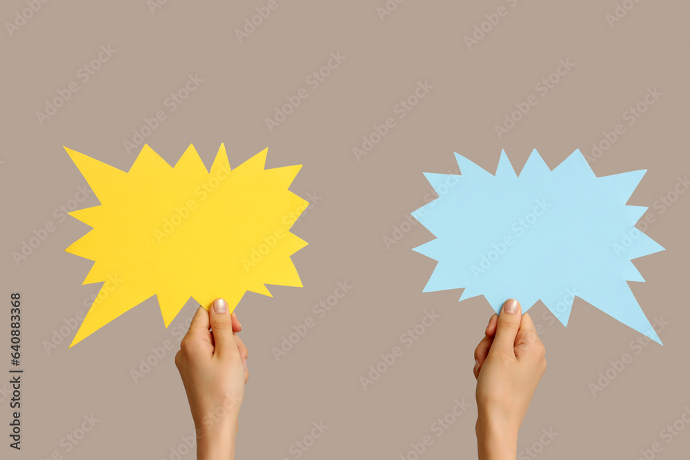 Female hands with speech bubbles on grey background