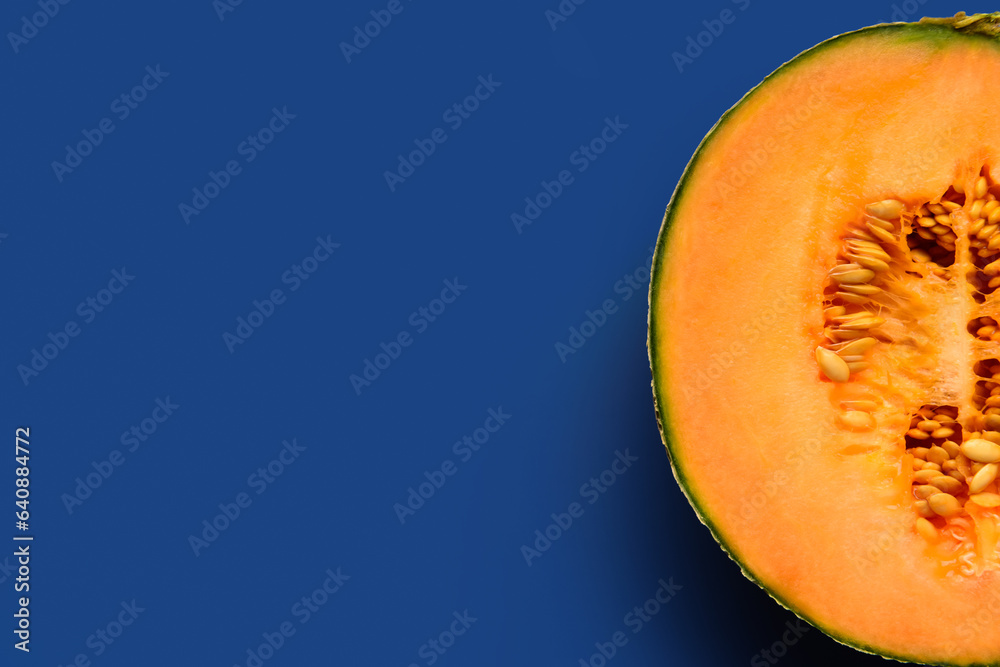 Half of sweet melon on blue background