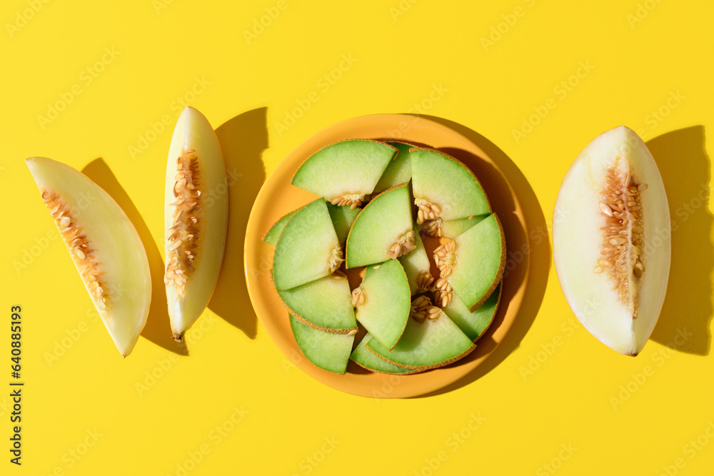 Plate with pieces of sweet melon on yellow background