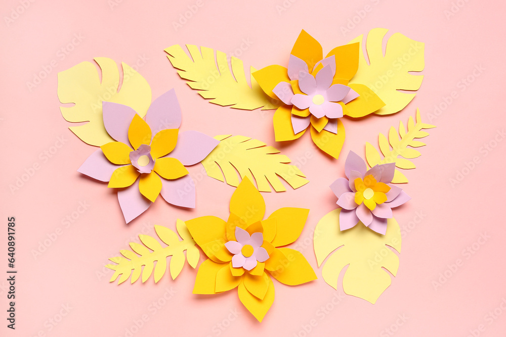 Colorful origami flowers with leaves on pink background