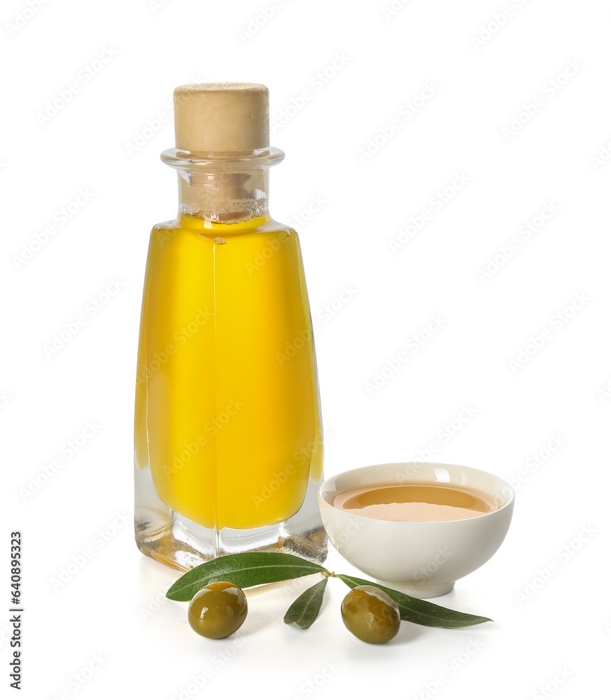 Bottle and bowl of fresh olive oil on white background