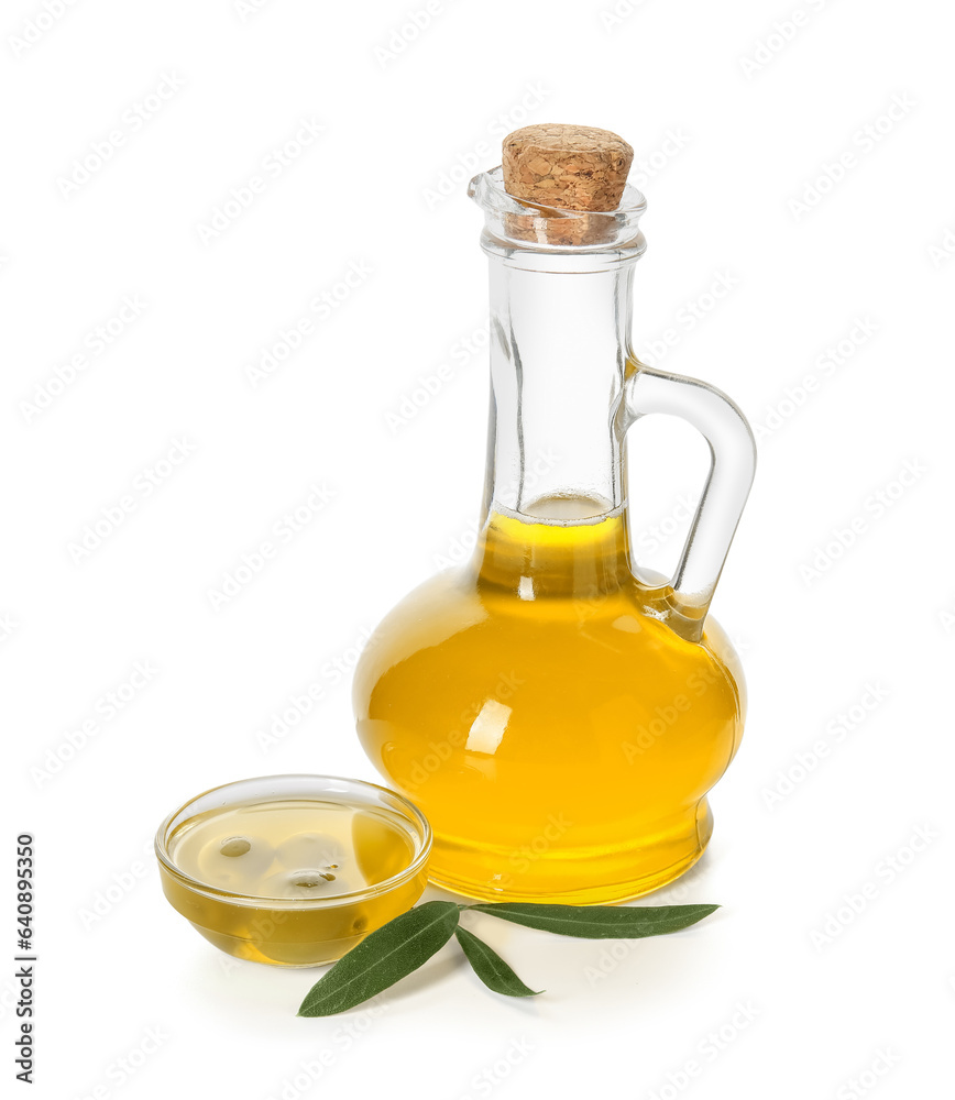 Jug and bowl of fresh olive oil on white background