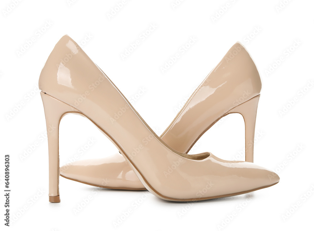 Stylish beige high heels on white background