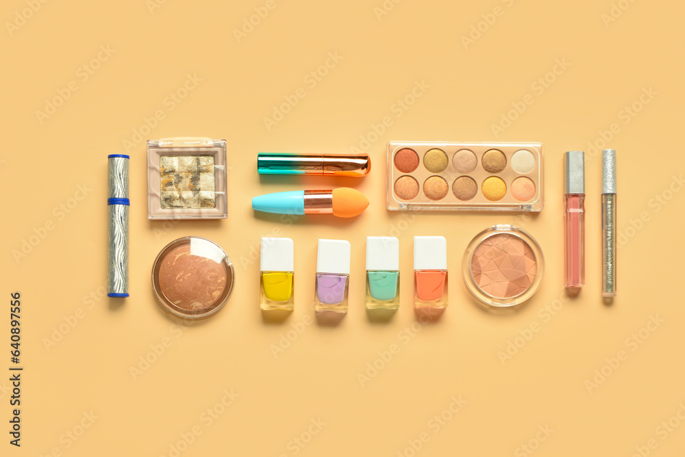 Different decorative cosmetics on yellow background