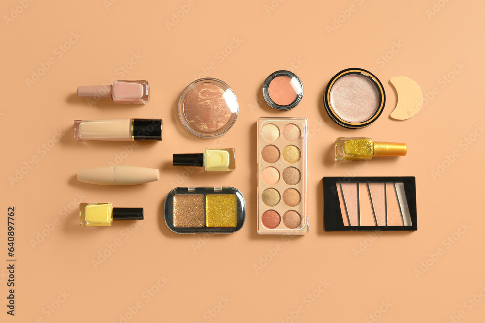 Different decorative cosmetics on orange background