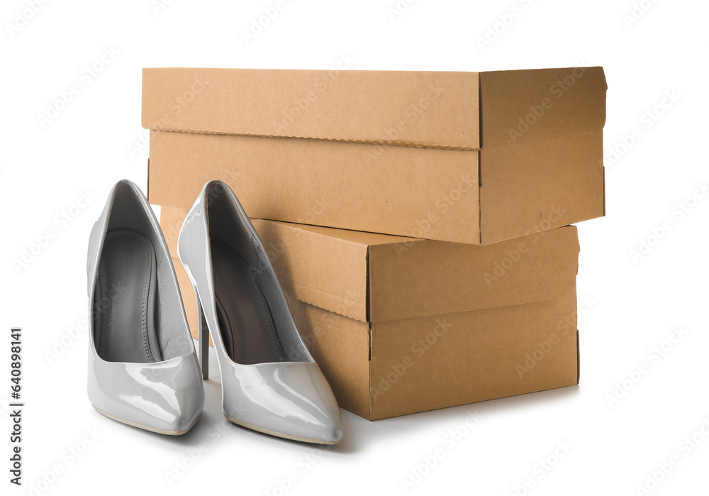 Stylish grey high heels and boxes on white background