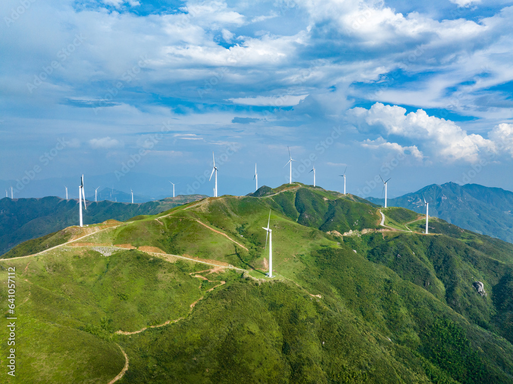 Wind power on the mountain, blue sky and white clouds