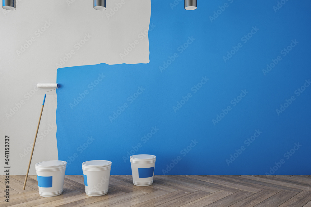 Clean interior with blue paint on concrete wall, painting tools, ladder, lamps and wooden flooring. 