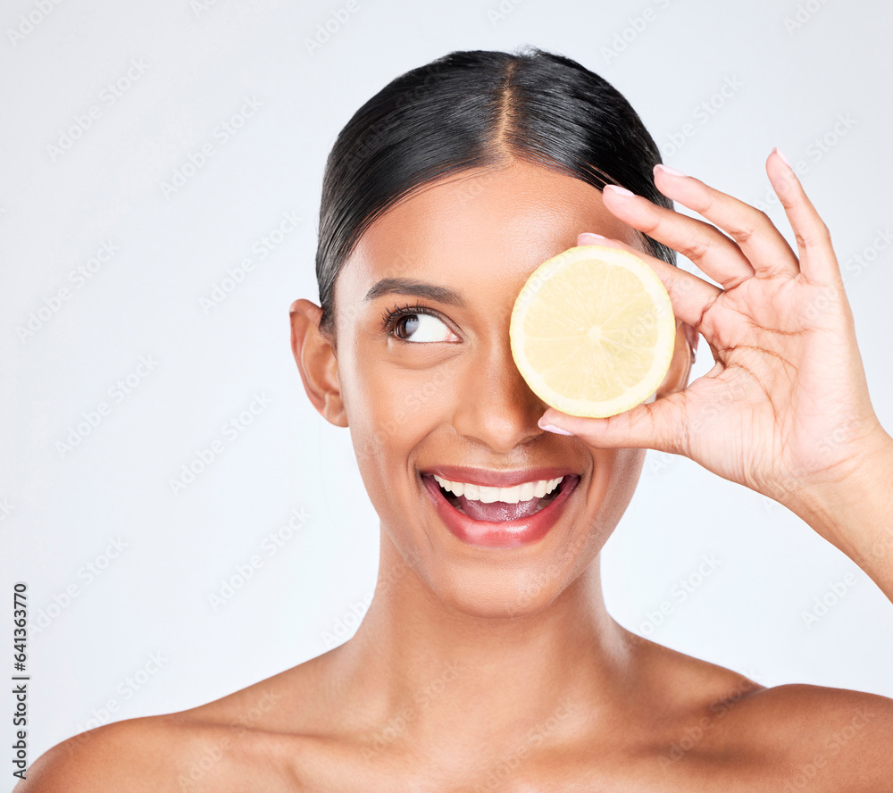 Face, beauty and lemon with a natural woman in studio on a white background for vitamin C nutrition.